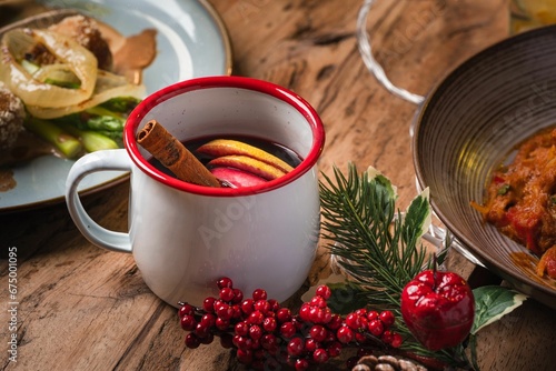 Closeup of a cup of glintwine on a Christmas-themed table photo