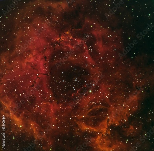 Rosette Nebula, also known as Caldwell 49, is a large, spherical H II region in space photo
