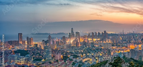 Night skyline of Qingdao, Shandong province, in China, illuminated by a gorgeous sunset.