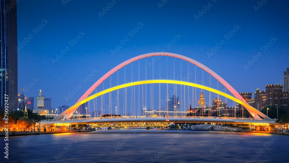 Naklejka premium arts bridge and the city at night on the river danube
