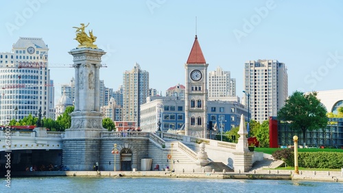 Cityscape, Bei'an Bridge and Church Tower Bell along the Haihe River, Tianjin, China photo