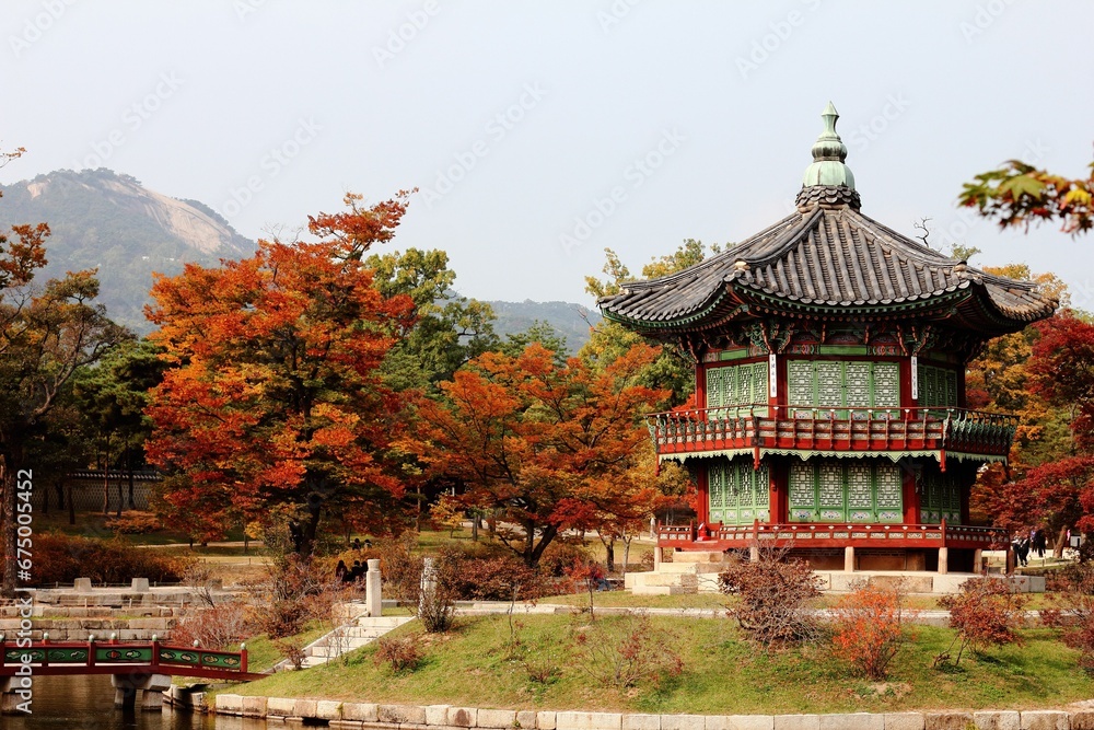 View of Hyangwonjeong Pavilion surrounded by colorful trees. Gyeongbokgung Palace, South Korea.