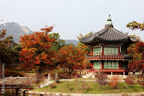 View of Hyangwonjeong Pavilion surrounded by colorful trees. Gyeongbokgung Palace, South Korea.
