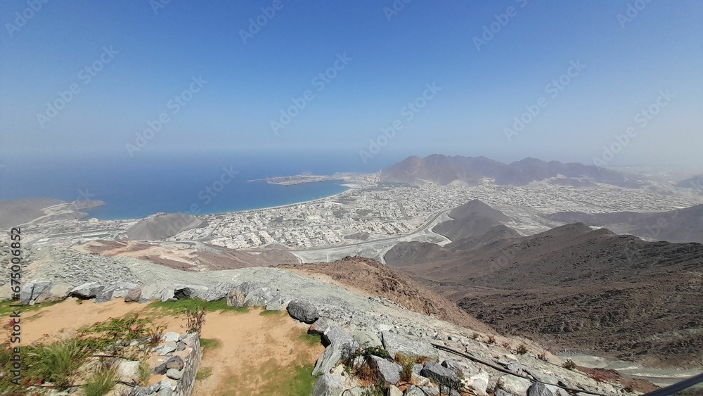 view of a wide city from a tall mountain in the desert