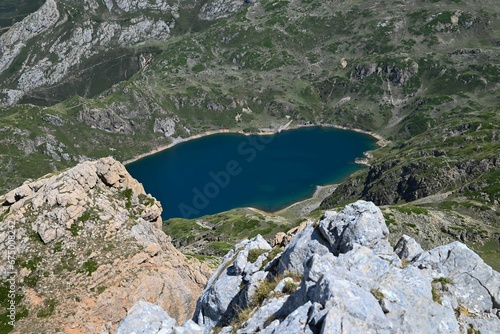 Fototapeta Naklejka Na Ścianę i Meble -  an aerial of Somiedo lakes surrounded by rocky mountains covered with green grass