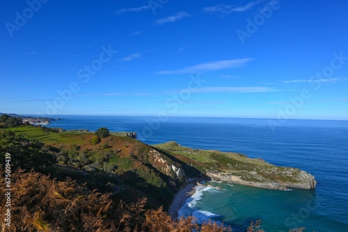 Picturesque seascape featuring dramatic coastal cliffs overlooking the peaceful blue waters