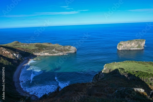 Picturesque seascape featuring dramatic coastal cliffs overlooking the peaceful blue waters photo