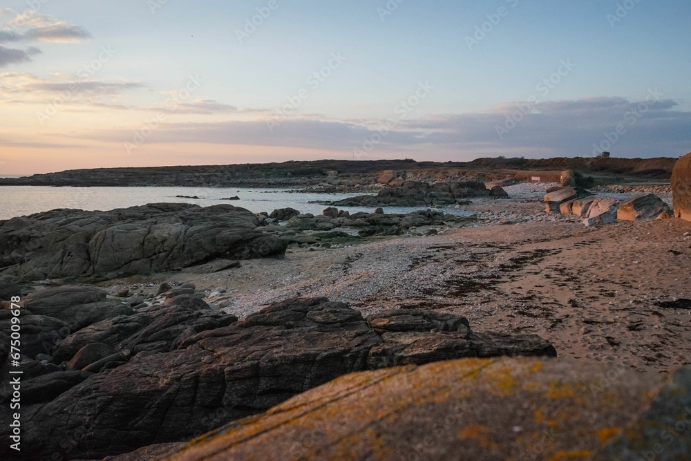 Picturesque beach scene with a stunning sunset backdrop in Brittany, France