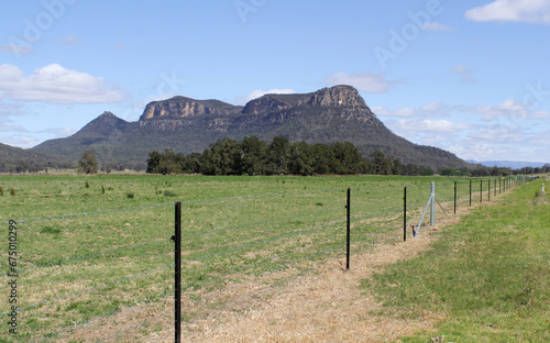 Mountain with a fence and a field of grass in the Capertee Valley in New South Wales, Australia