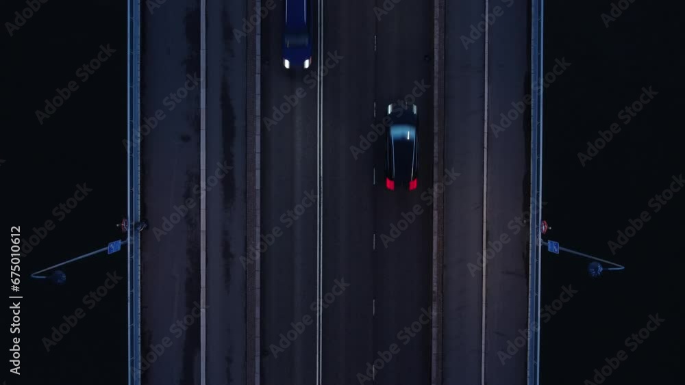Aerial looks directly down on to bridge deck traffic during blue hour Aerial looks directly down on to bridge deck traffic during blue hour