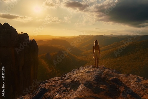 Woman standing on a large rocky outcrop with a breathtaking view of the valley below, AI-generated.