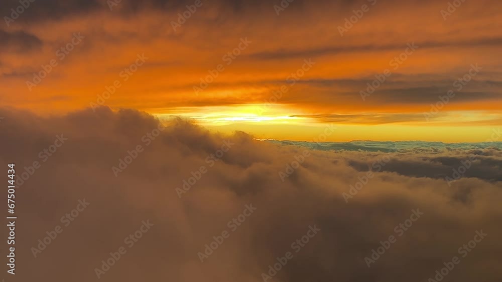 Spectacular red sunset shot from an airplane cabin while flying at cruise level 10000m high with the sun veiled ahead. A pilot’s perspective. Spectacular red sunset shot from an airplane cabin while flying at cruise level 10000m high with the sun veiled ahead. A pilot’s perspective.