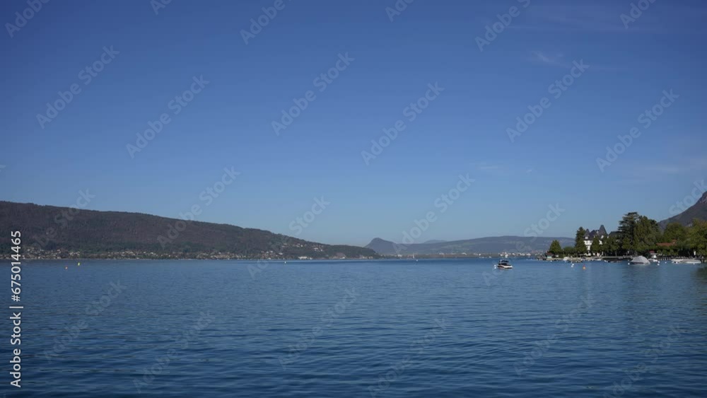 Lake Annecy in the French Alps with boat parked right, Wide stable shot Lake Annecy in the French Alps with boat parked right, Wide stable shot