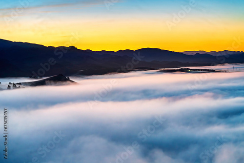 Cloud inversion over valley at sunrise  sunset  with mountains