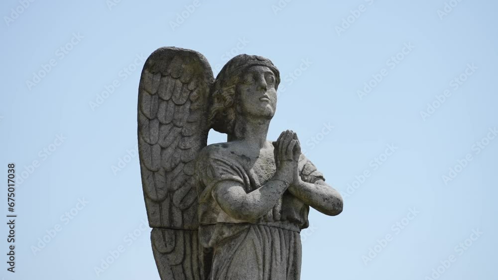Praying stone angel statue with intricate wings at Sameiro Sanctuary Praying stone angel statue with intricate wings at Sameiro Sanctuary