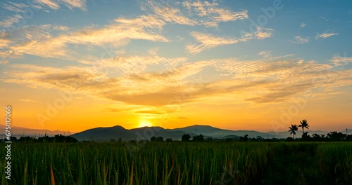 Time-lapse from dawn to sunrise over the rice fields with beautiful sky and clouds and anti-crepuscular rays at rural Chiang Mai province Thailand photo
