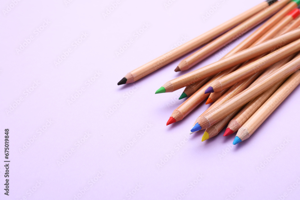 Many colorful pastel pencils on violet background, space for text. Drawing supplies Many colorful pastel pencils on violet background, space for text. Drawing supplies