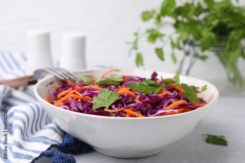 Tasty salad with red cabbage in bowl on light grey table, closeup Tasty salad with red cabbage in bowl on light grey table, closeup