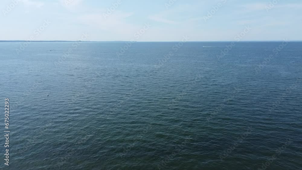 Drone view over tranquil sea coast during daytime