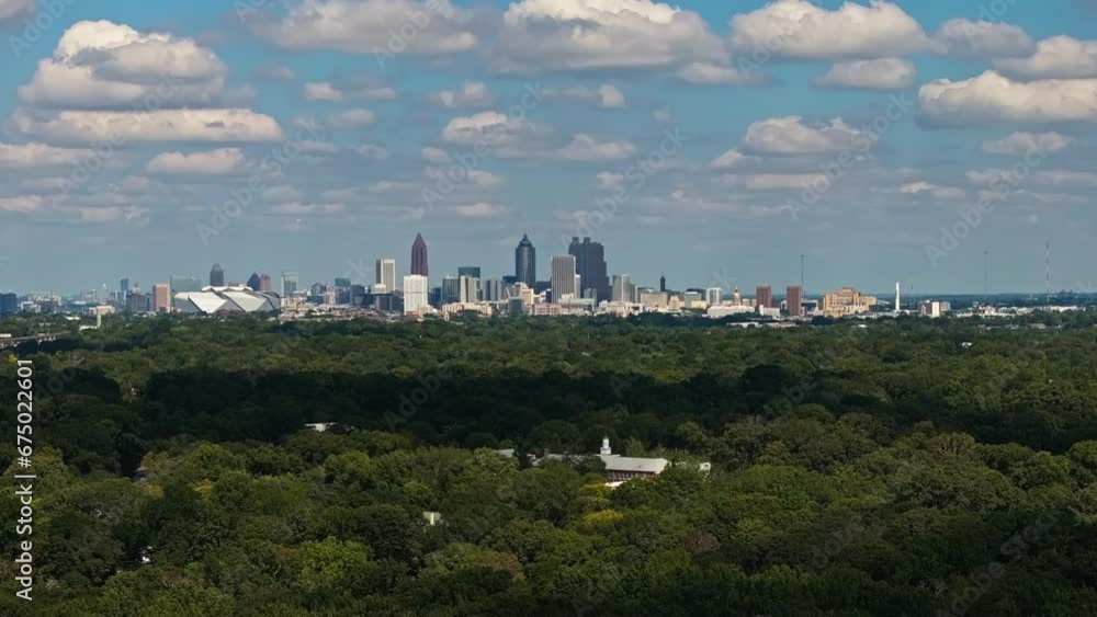 Aerial wide shot showing green forest and Skyline of Atlanta City during sunny day in America - View from suburb district Aerial wide shot showing green forest and Skyline of Atlanta City during sunny day in America - View from suburb district