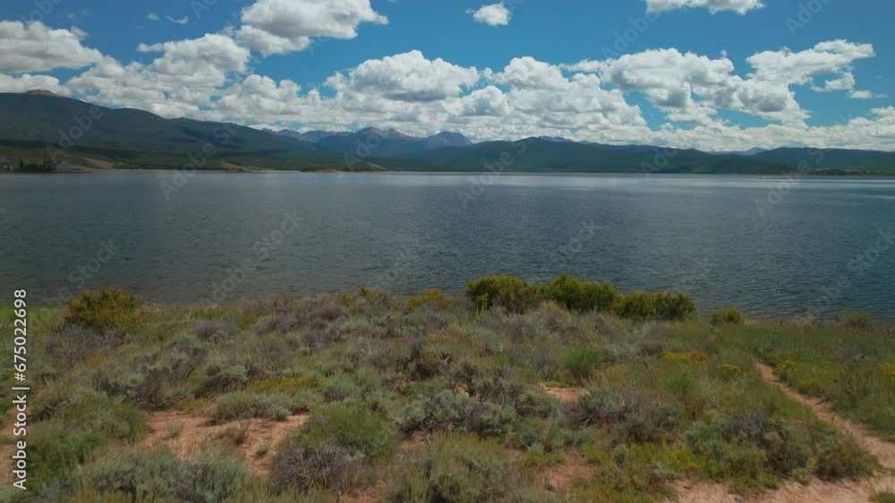 Aerial cinematic drone high altitude shore of Grand Lake Shadow Mountain Grandby Colorado Rocky Mountain National park entrance calm clear beautiful summer morning boating islands forward motion Aerial cinematic drone high altitude shore of Grand Lake Shadow Mountain Grandby Colorado Rocky Mountain National park entrance calm clear beautiful summer morning boating islands forward motion