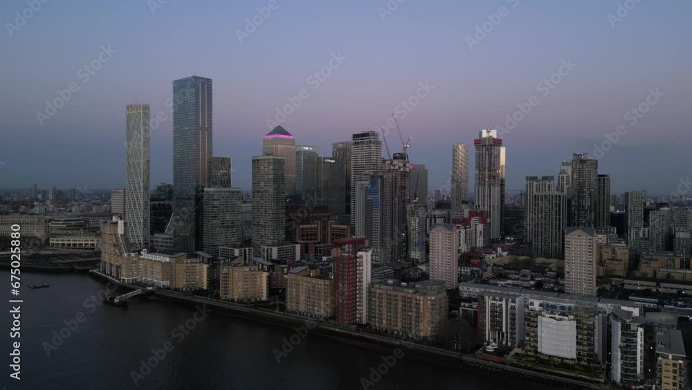 Blue hour aerial view of Canary Wharf skyline over River Thames, London Blue hour aerial view of Canary Wharf skyline over River Thames, London