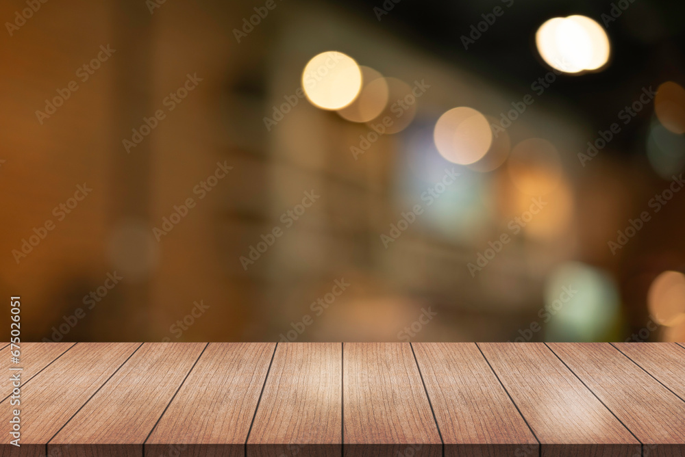 Empty wooden table top with lights bokeh on blur restaurant background Empty wooden table top with lights bokeh on blur restaurant background