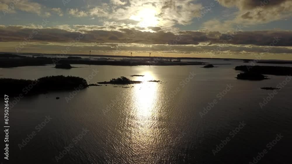 Drone view over island silhouettes in the water during sunset Drone view over island silhouettes in the water during sunset