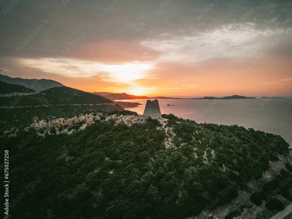 Tranquil landscape captured at sunrise with a watchtower on the coast of Italy Tranquil landscape captured at sunrise with a watchtower on the coast of Italy