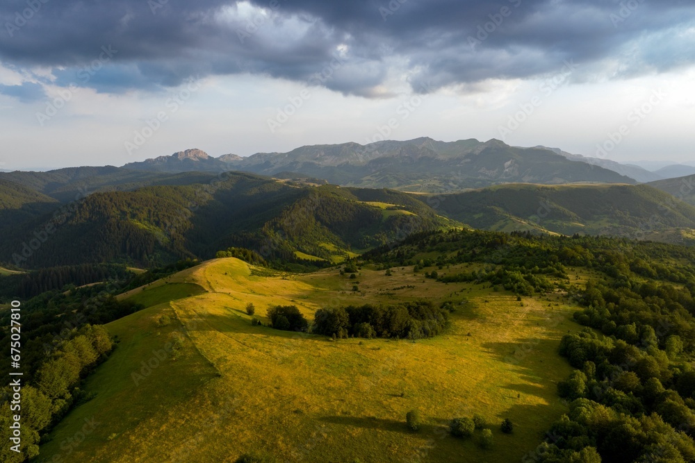 Obraz premium Aerial view of green hills on a sunny day