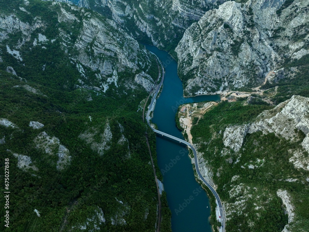 Aerial view of a river flowing through green mountains Aerial view of a river flowing through green mountains