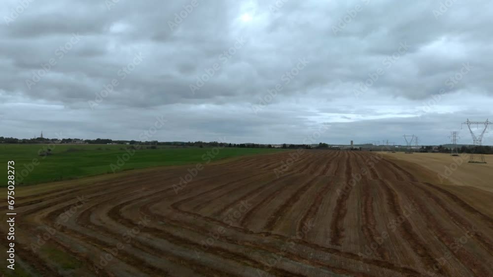Drone view over a harvested rural field on a cloudy day Drone view over a harvested rural field on a cloudy day