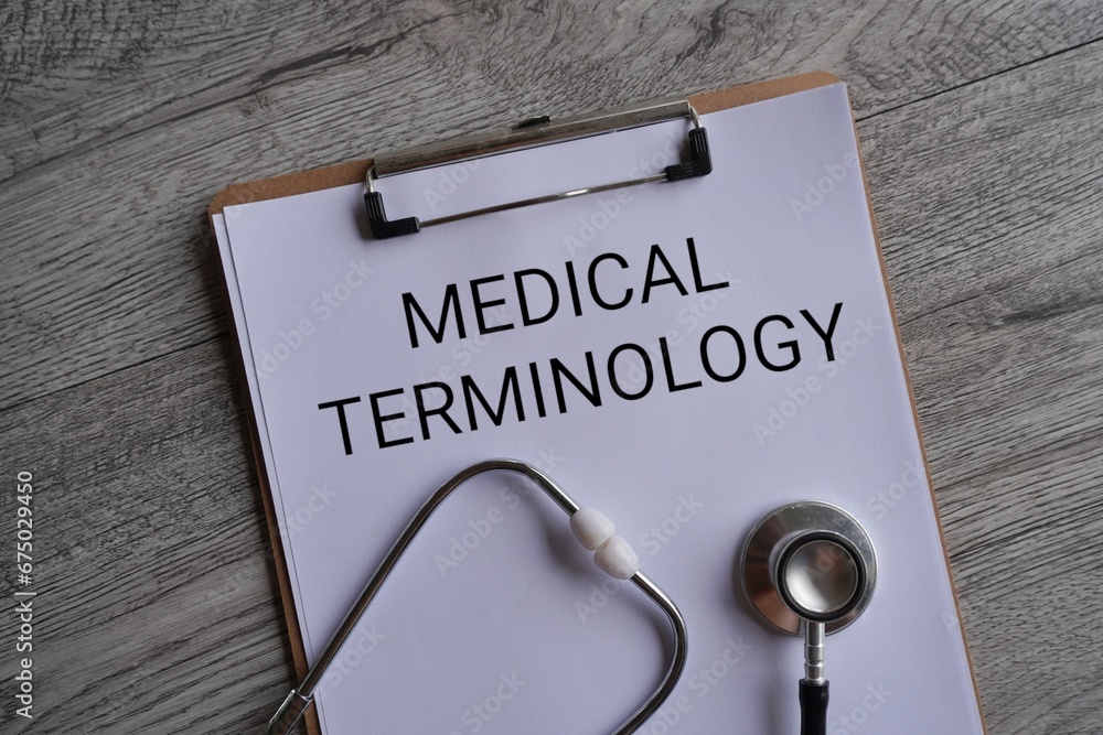 Top view image of stethoscope and paper clipboard with text MEDICAL TERMINOLOGY. Medical and healthcare concept. Top view image of stethoscope and paper clipboard with text MEDICAL TERMINOLOGY. Medical and healthcare concept.