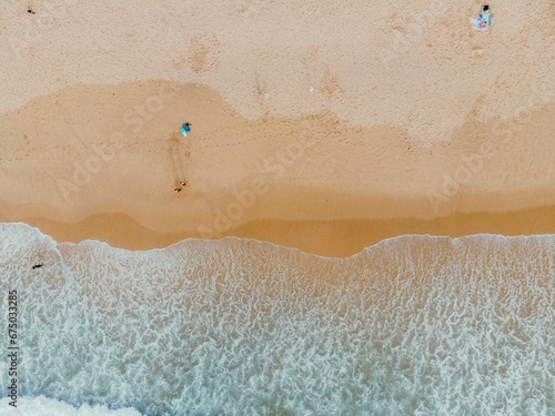 Top view of a serene beach with the waves lapping the shore photo