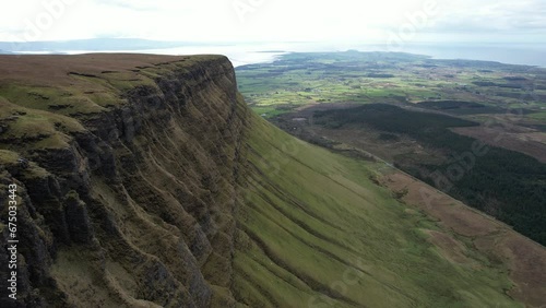 Drone footage over Benbulbin mountain rock formation and green valley photo