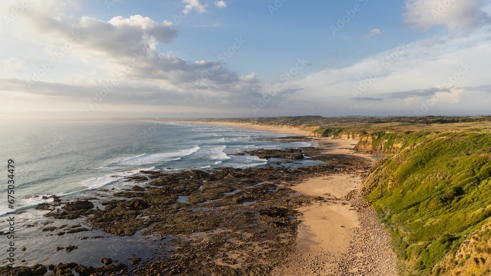 a beach with a long pathway going down to the ocean