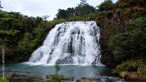 Scenic landscape view of beautiful Owharoa Waterfalls surrounded by native flora and fauna in New Zealand Aotearoa photo