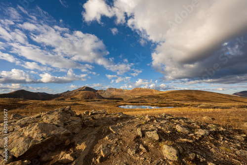 Beautiful aerial view of Independence Pass in Colorado with a vibrant sky full of fluffy clouds © Wirestock