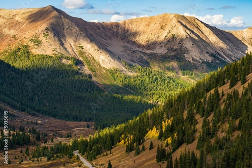 Aerial view of Independence Pass, Colorado with a rocky mountain range and lush forests