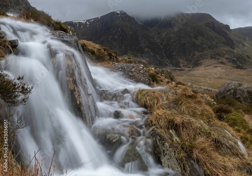 Majestic waterfall cascades down a rugged hillside in the Y Garn Mountains of Wales