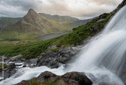 Majestic waterfall cascading down a rocky mountain face near Ogwen Valley