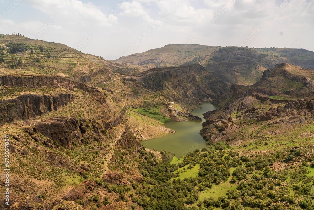 Obraz premium Aerial view of a water dam surrounded by greenery in Ibb city, Yemen