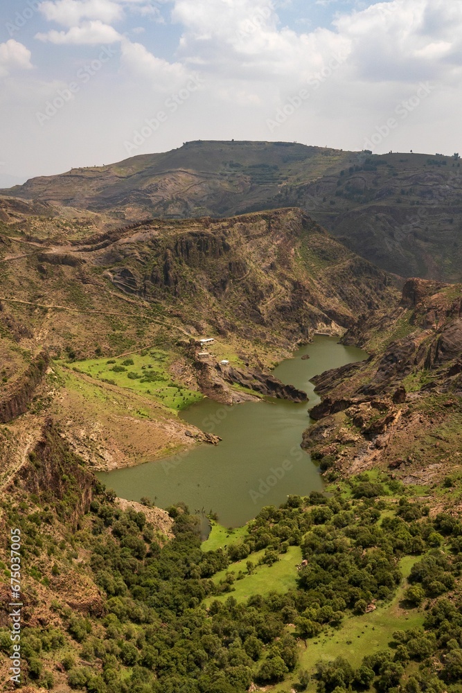 Obraz premium Aerial view of a water dam surrounded by greenery in Ibb city, Yemen