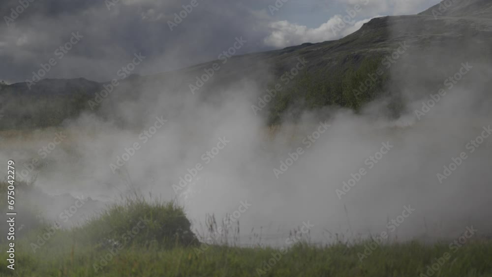 Geysers and steam rising from the ground at Strokkur Geyser, Iceland Geysers and steam rising from the ground at Strokkur Geyser, Iceland