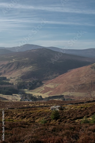 Vertical shot of Wicklow Mountains under the cloudy blue sky