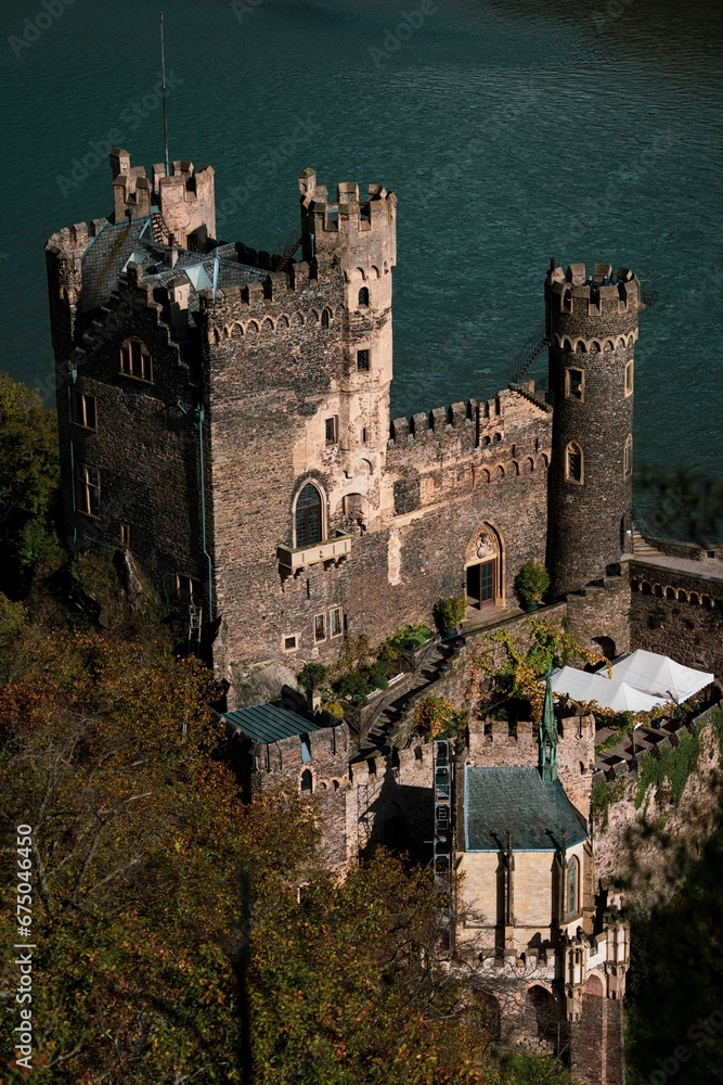 the castle is very high on a cliff near a lake the castle is very high on a cliff near a lake