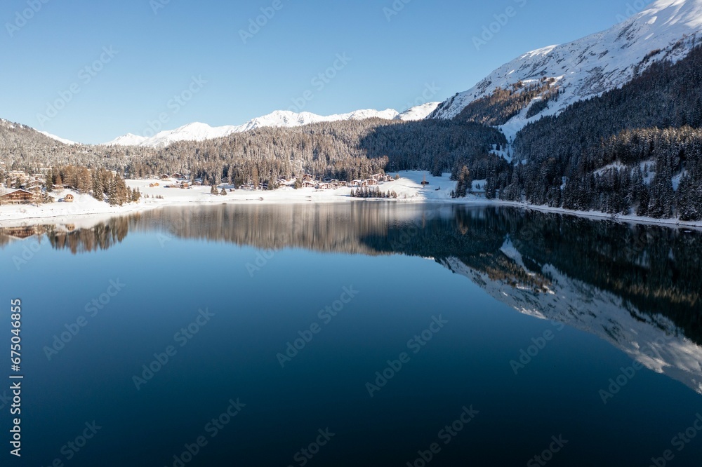 Landscape of Lake Davos surrounded by snowy hills in Switzerland