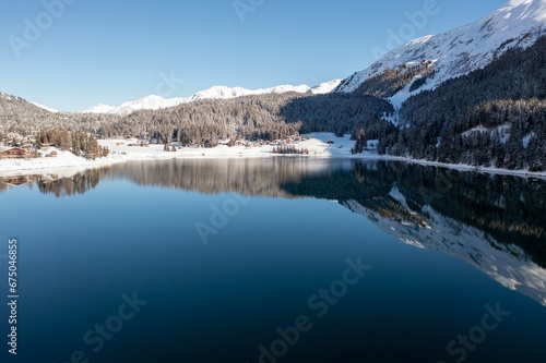 Landscape of Lake Davos surrounded by snowy hills in Switzerland