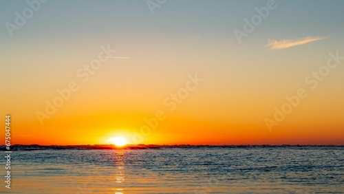 Scenic view of a beautiful sunset over the tranquil sea © Wirestock