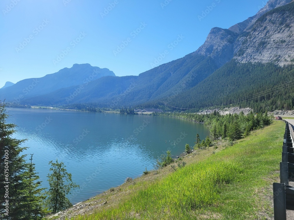 Scenic landscape featuring a mountain range in the backdrop with a tranquil body of water